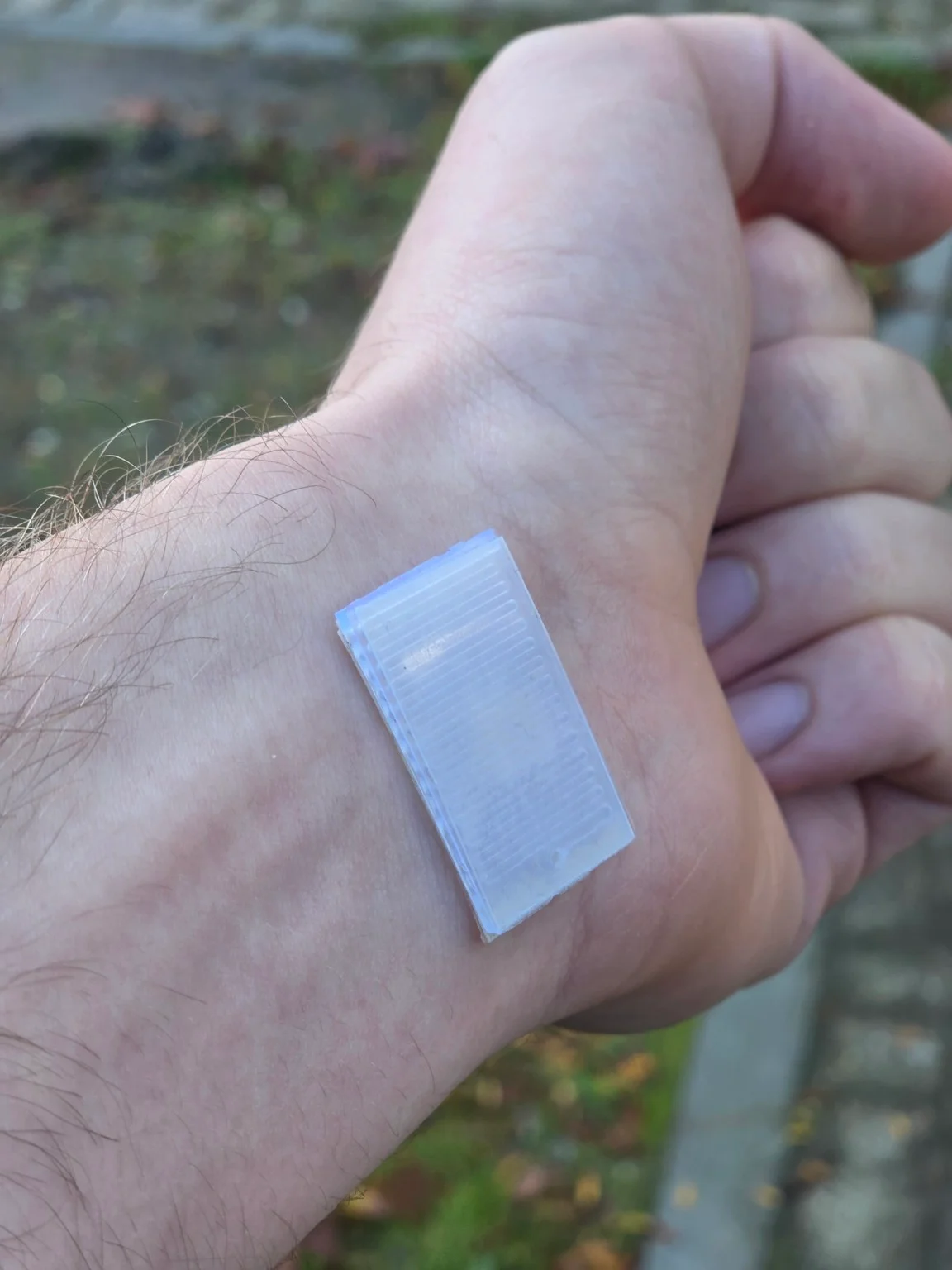 Microfluidic cartridge with a serpentine reservoir worn on the wrist